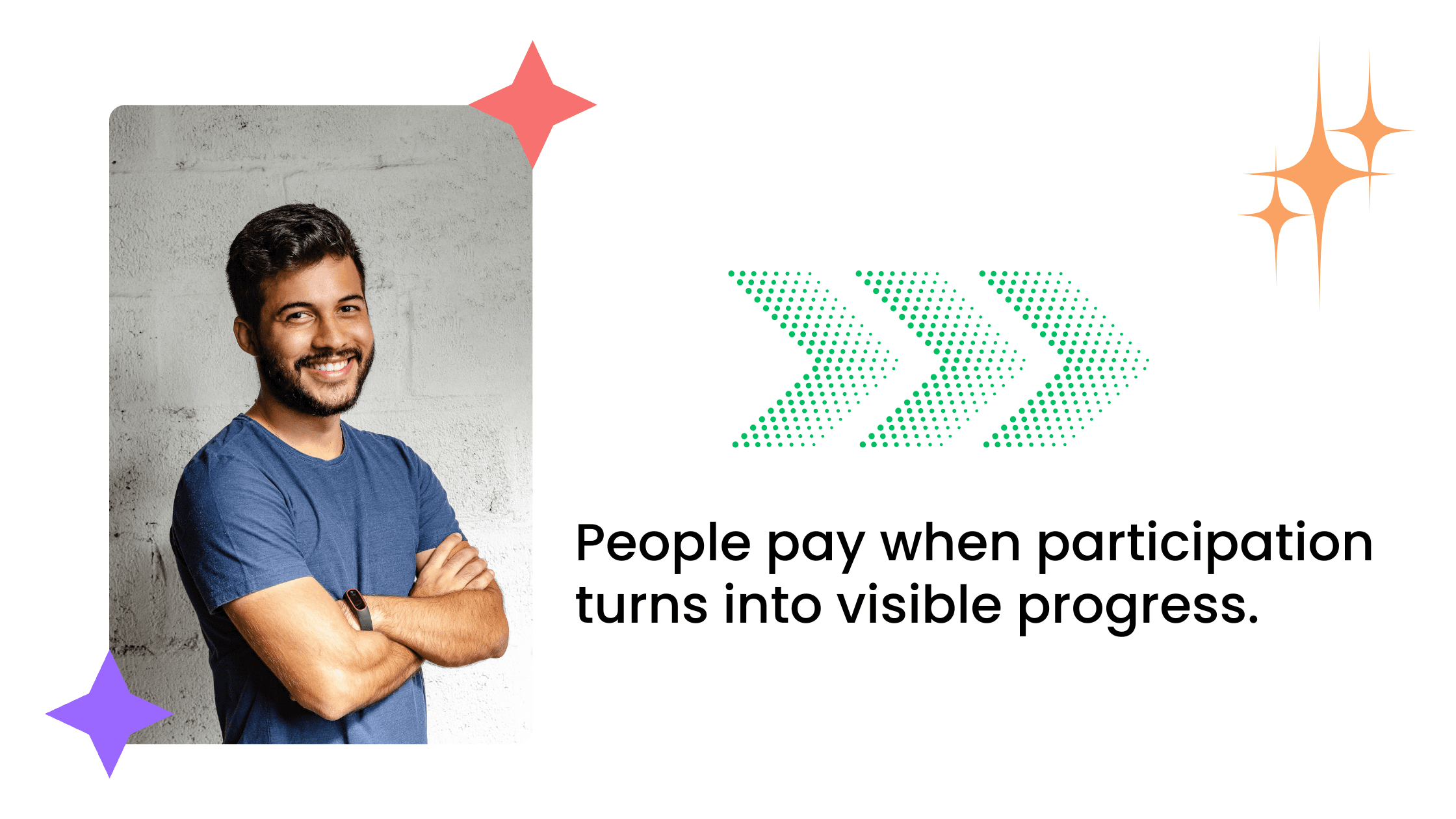 Smiling man with arms crossed standing against a gray wall background.