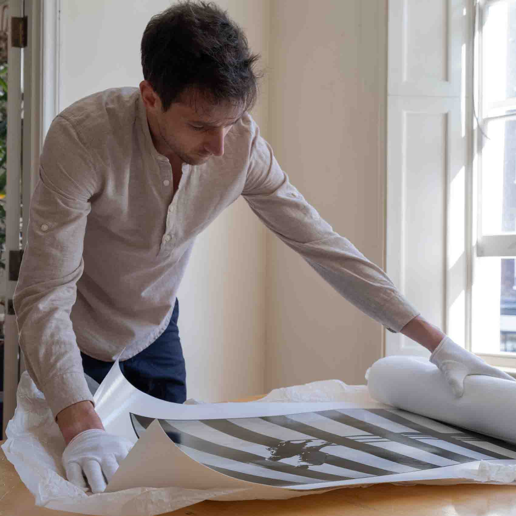 A photographer inspecting a panoramic print on a table