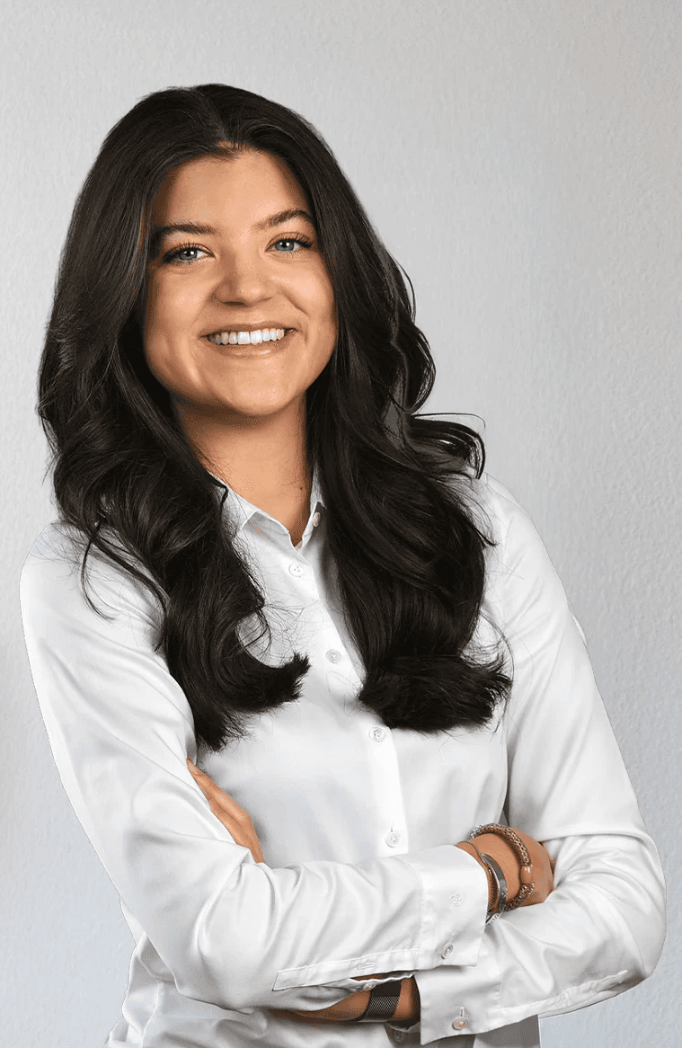 Portrait of a laughing person with curly hair wearing a white shirt