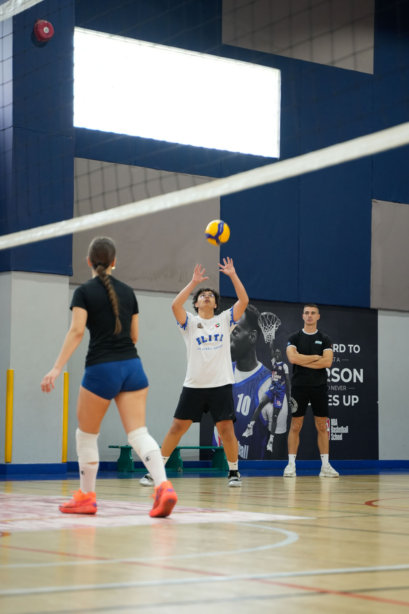 Students doing indor's Volleyball training