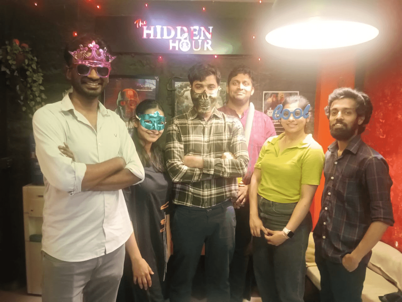 Teammates posing with props after playing mystery escape games