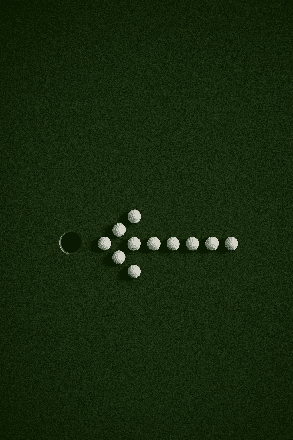 a green grass with a hole and golf balls arranged in the arrow shape