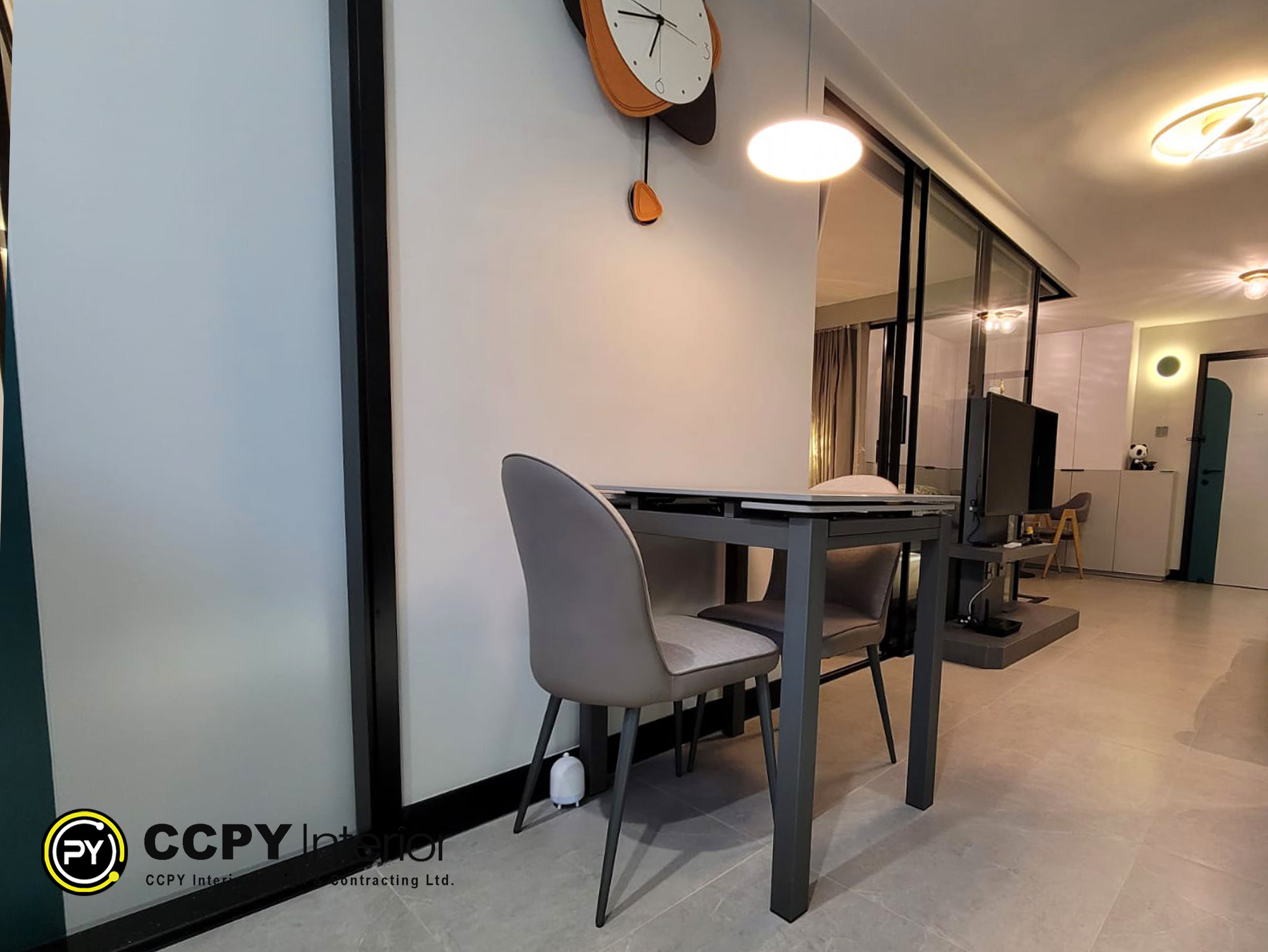 This is a hotel-style modern dining set featuring grey upholstered chairs and a dark metal table from an CCPY interior residential project
