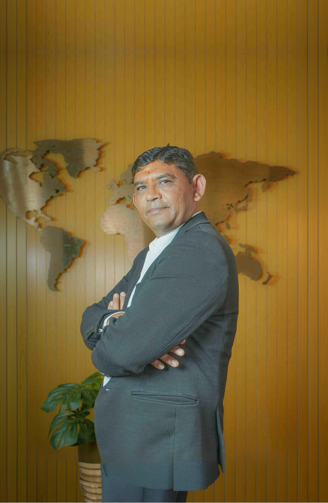A man in a suit sits at a desk.