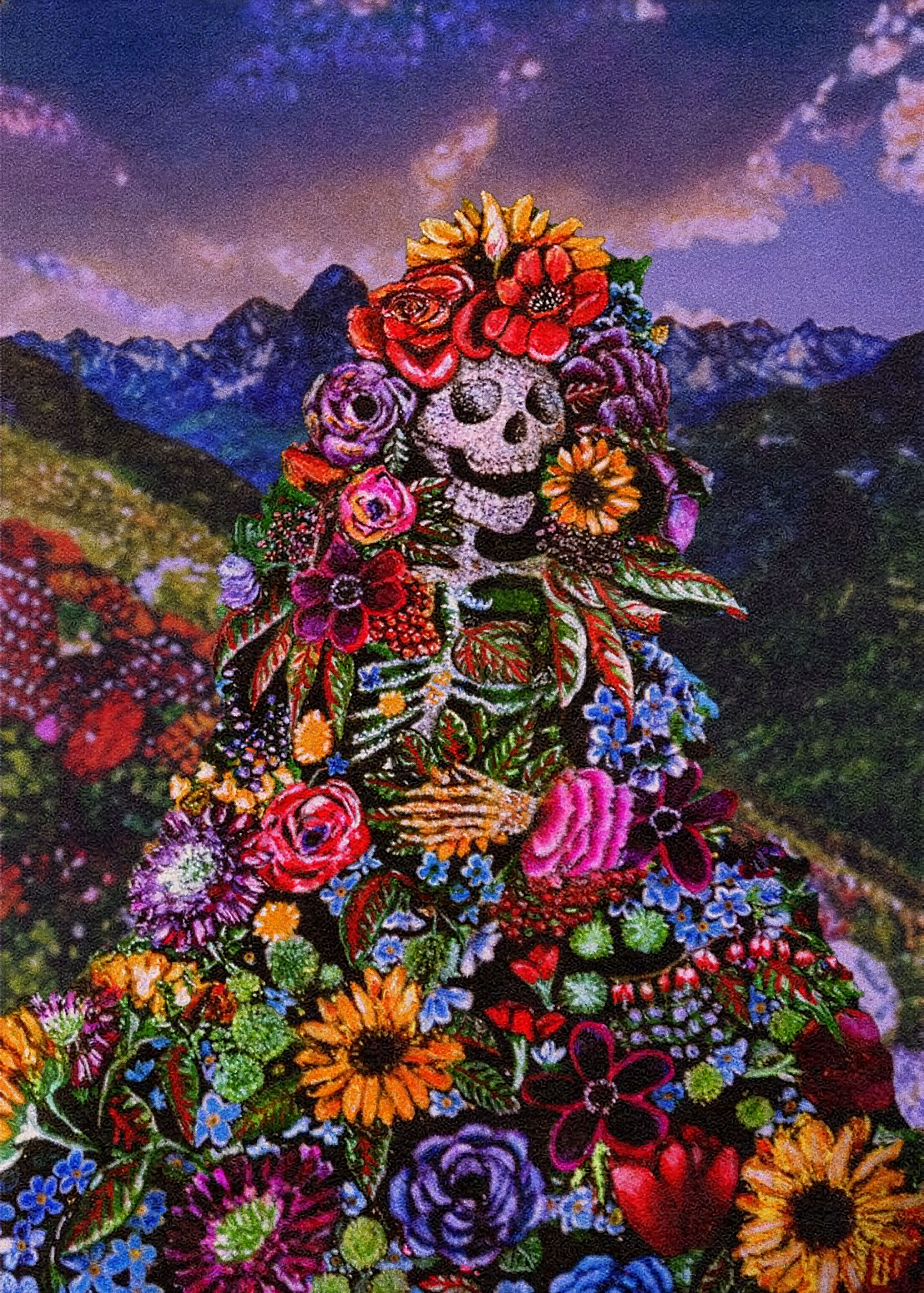 Mixed media painting by Iri Allis Heistand of a diamond encrusted skeleton wearing a cape of vibrant flowers standing before a mountain range.