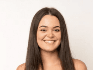 A smiling happy customer with curly hair on a blue background