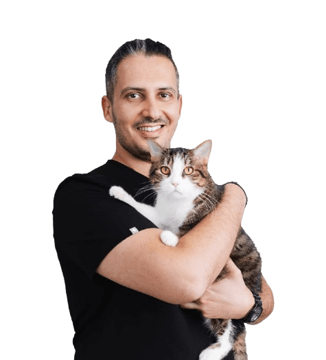 An image of Dr. J holding a cat in his arms.