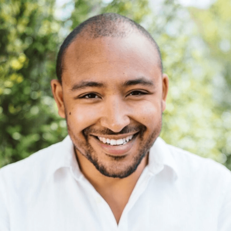 A person smiling and posing for a photo.