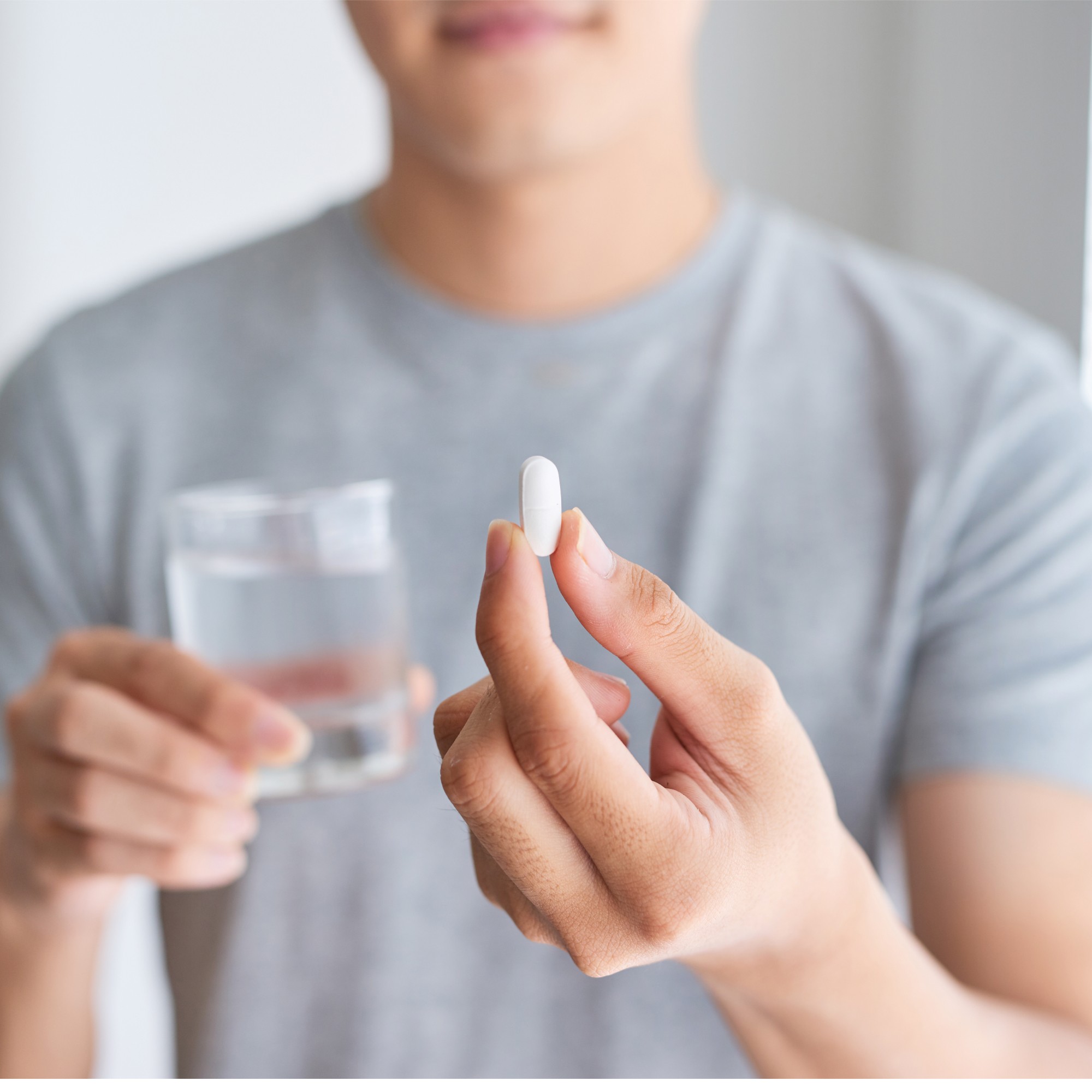 person holding a pill