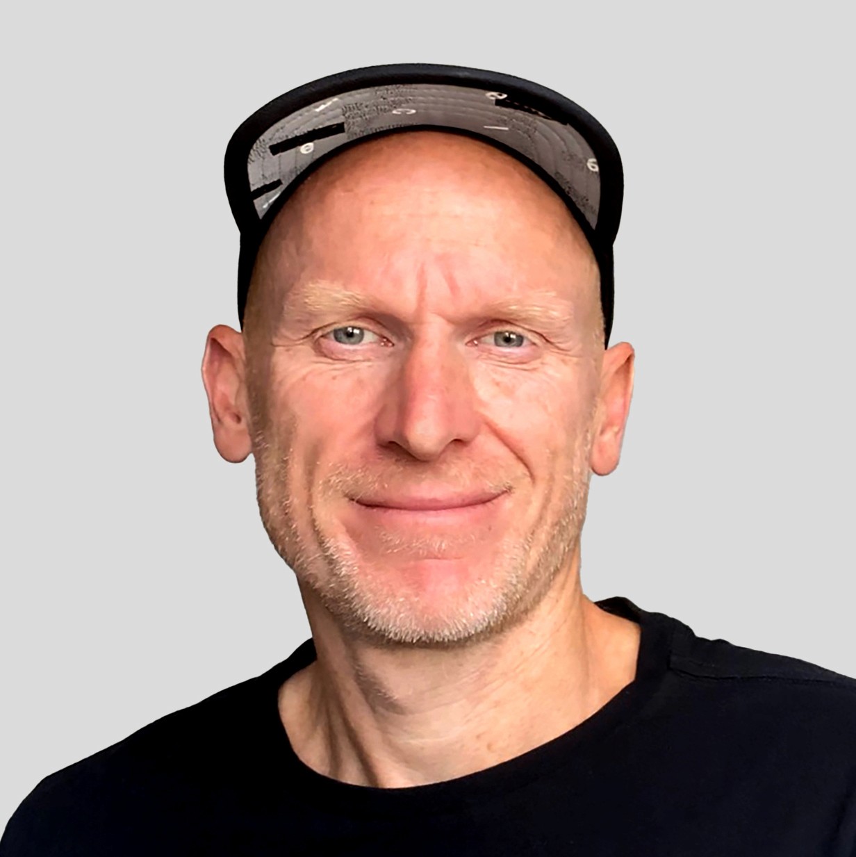 Profile portrait of a man in a grey shirt