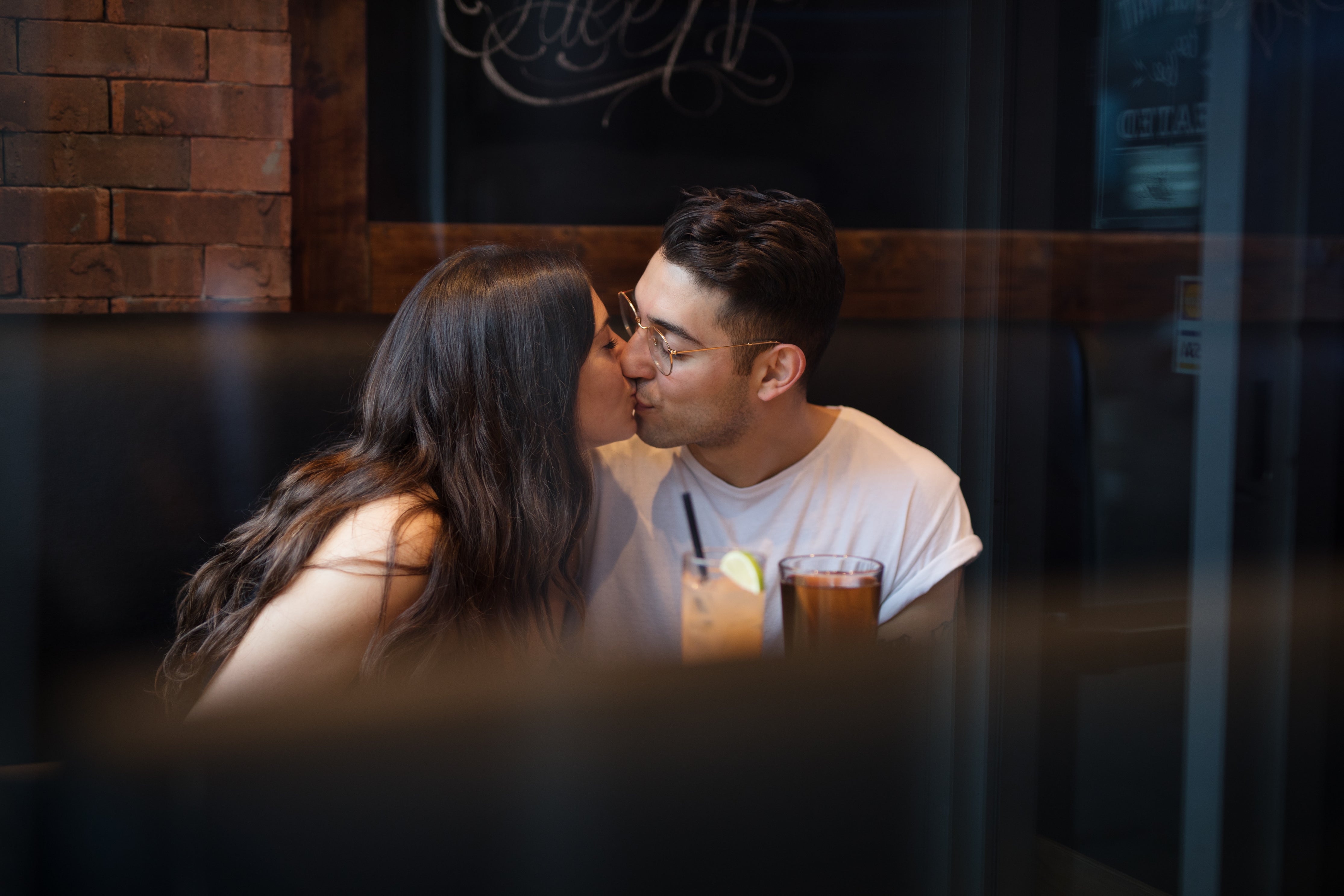 Couple kissing in a bar