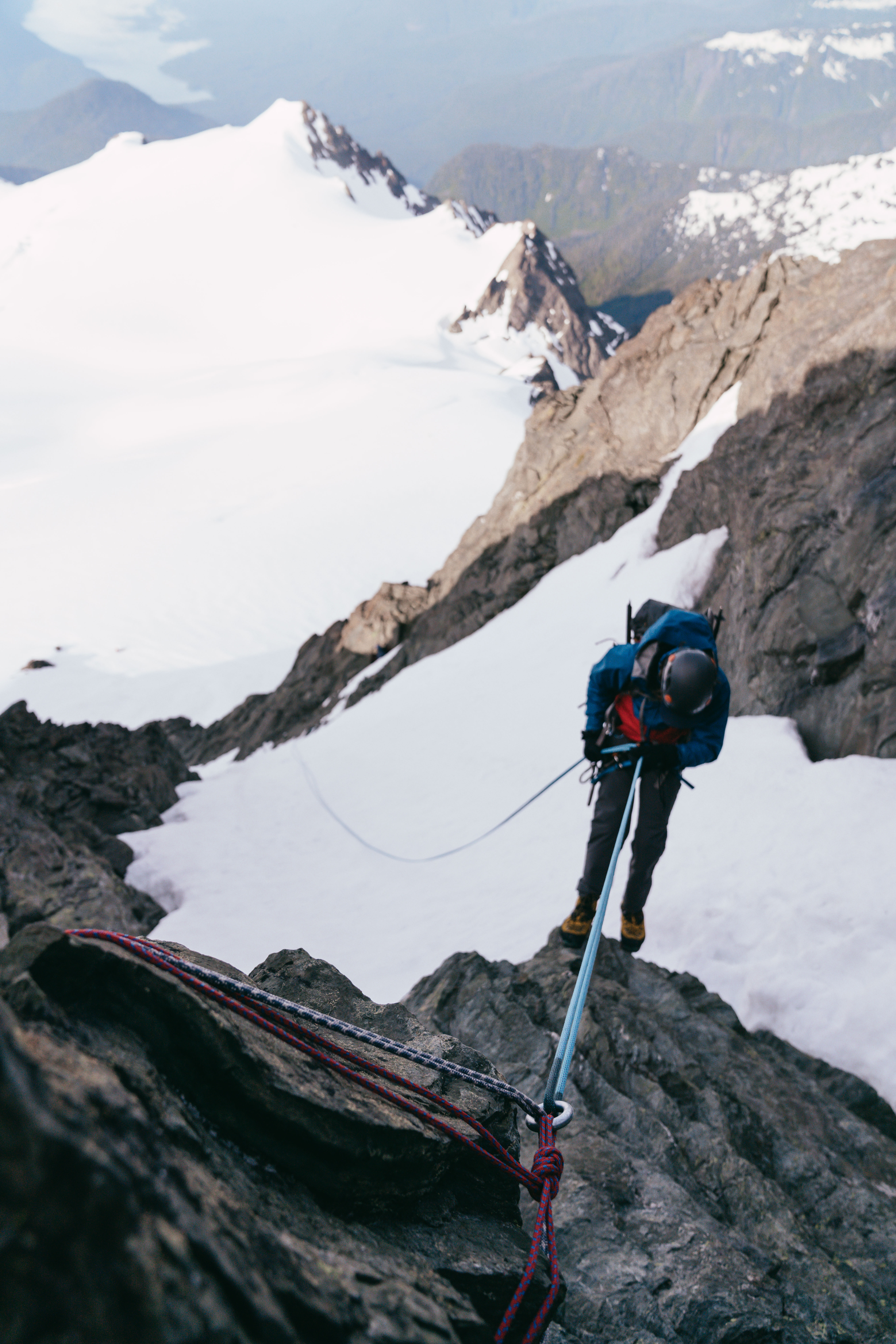 two person walking towards mountain covered with snow