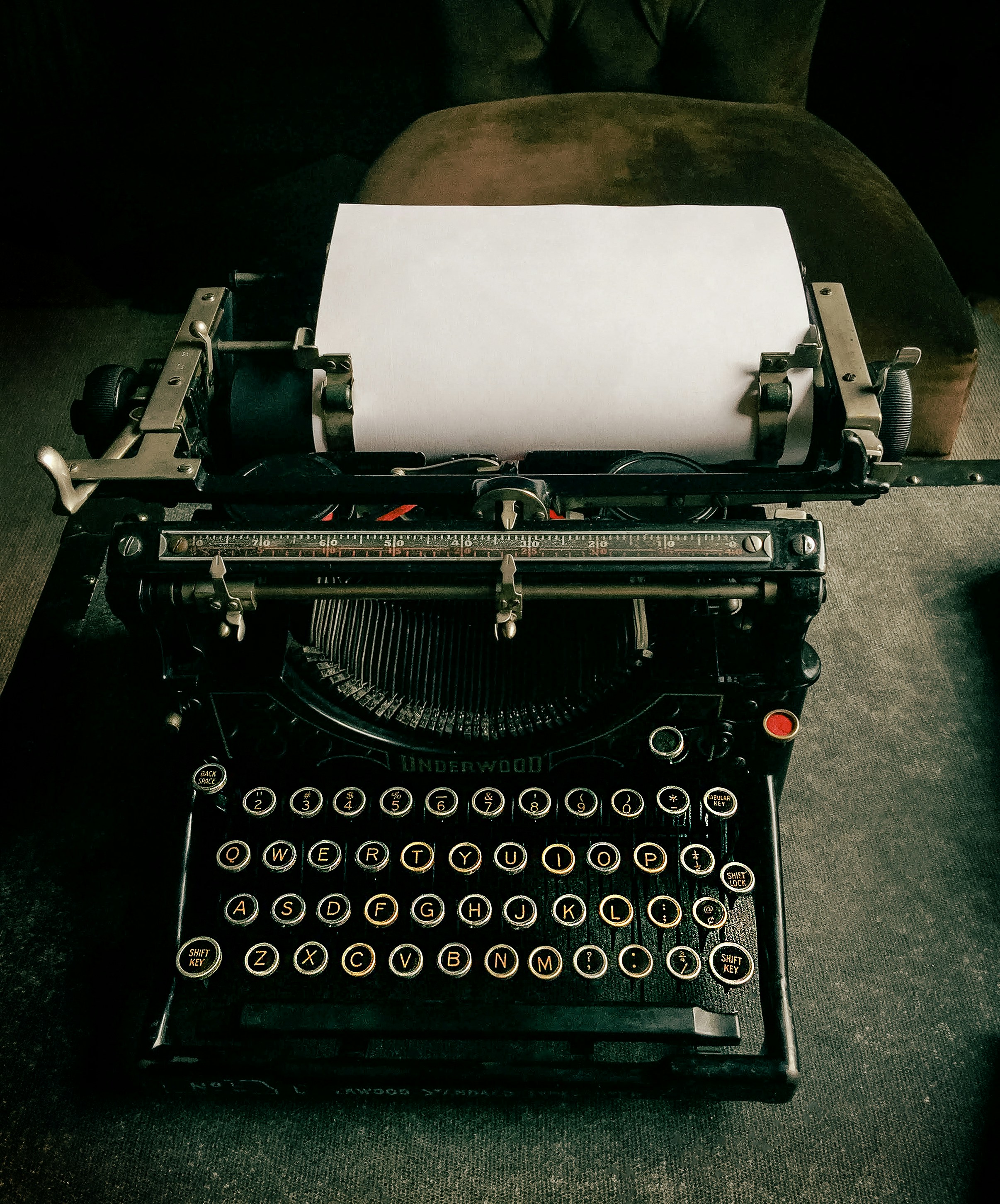 an old fashioned typewriter with a sheet of paper on top of it