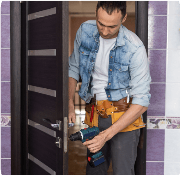 Man fixing a door lock.