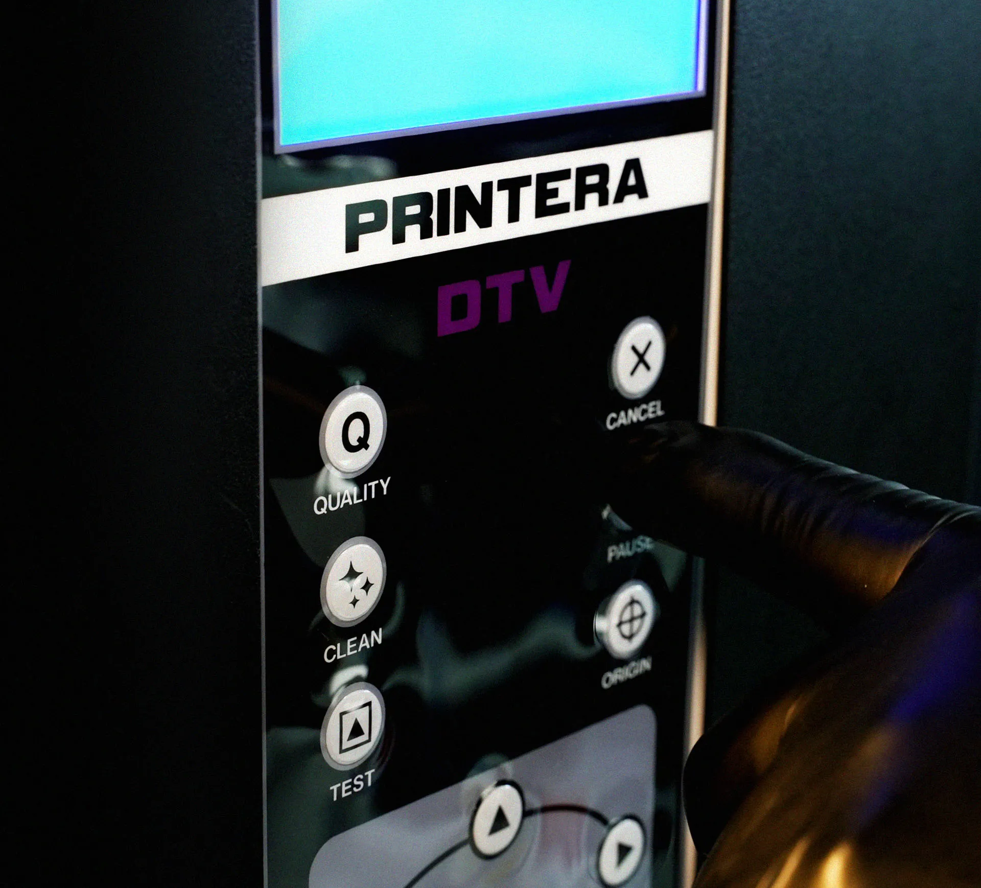 A worker easily operating the Printera Pro UV DTF printer using the intuitive front control panel, eliminating complex manual processes