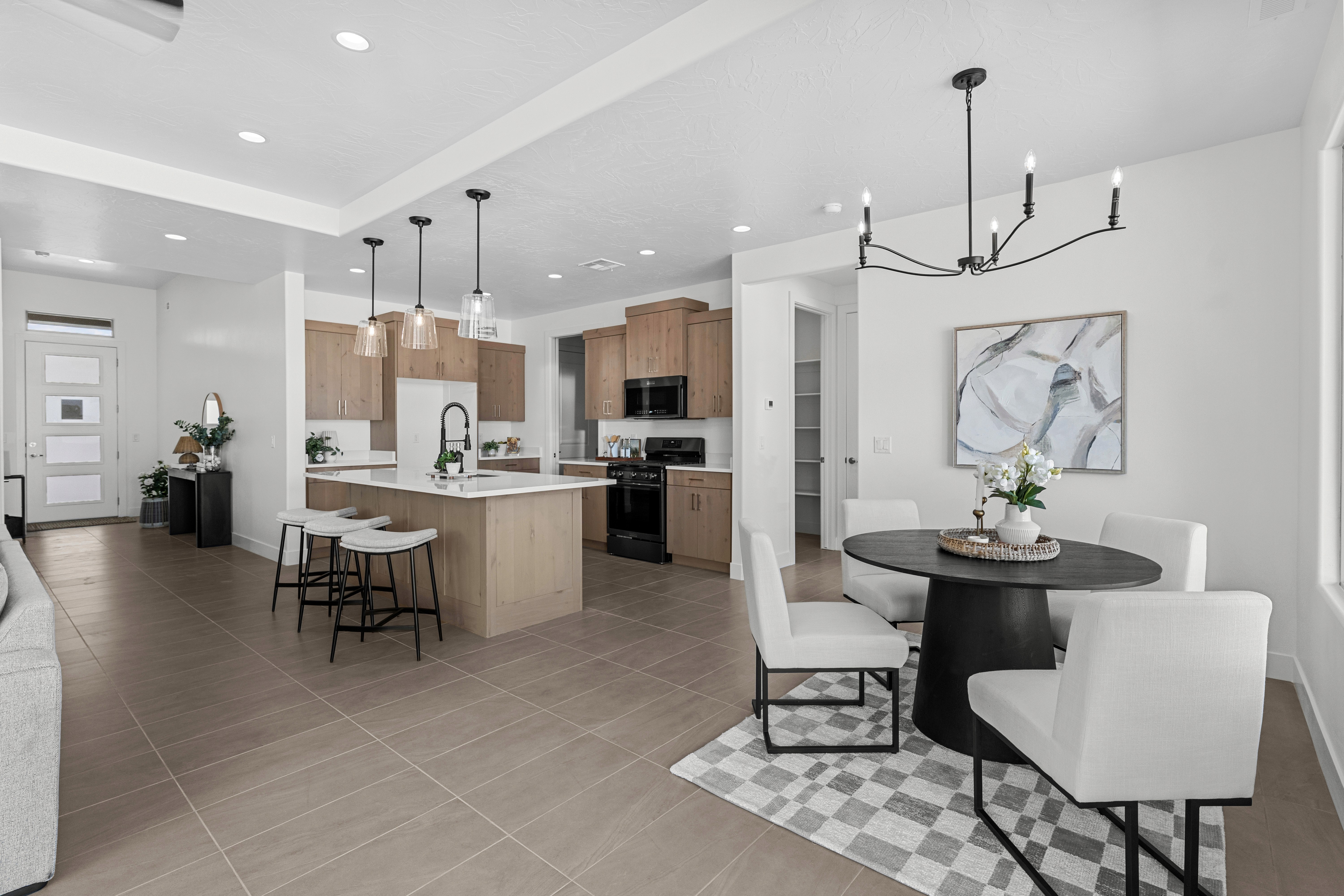 Dining room looking toward the kitchen in The Nest at Falcon Ridge, Hurricane, Utah, showcasing open-concept design and connection to living spaces.
