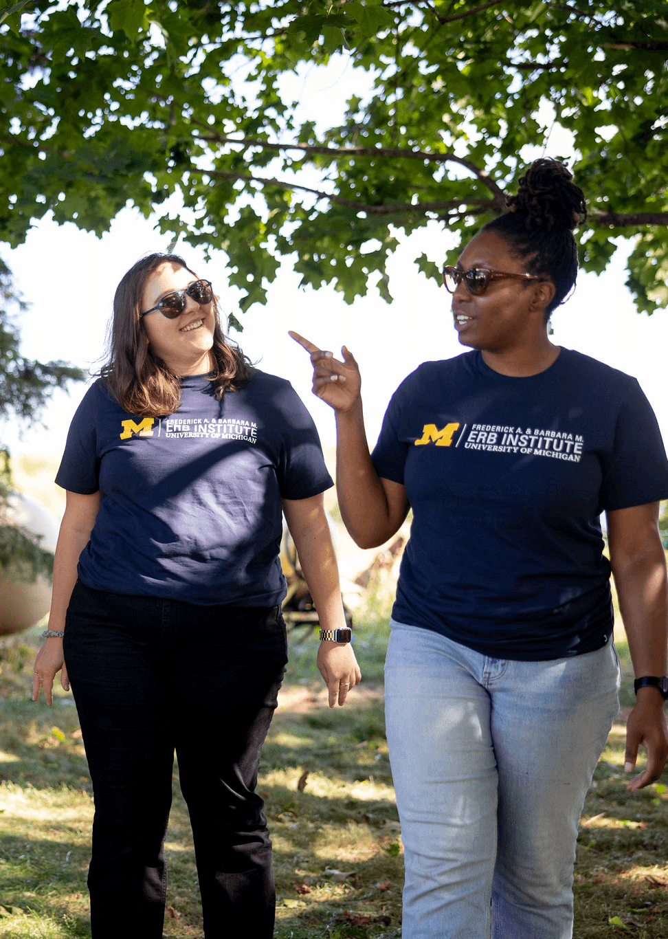 Group of students talk in front of trees