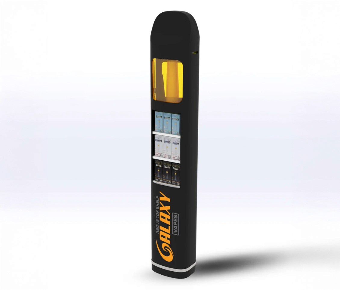 Close-up of hand holding pink ice cream cone against pastel background