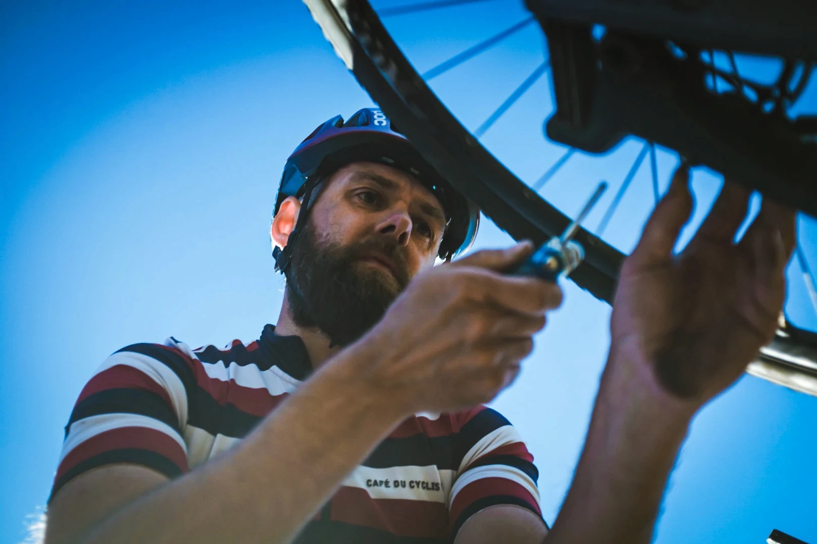 A bike mechanic fixes bike