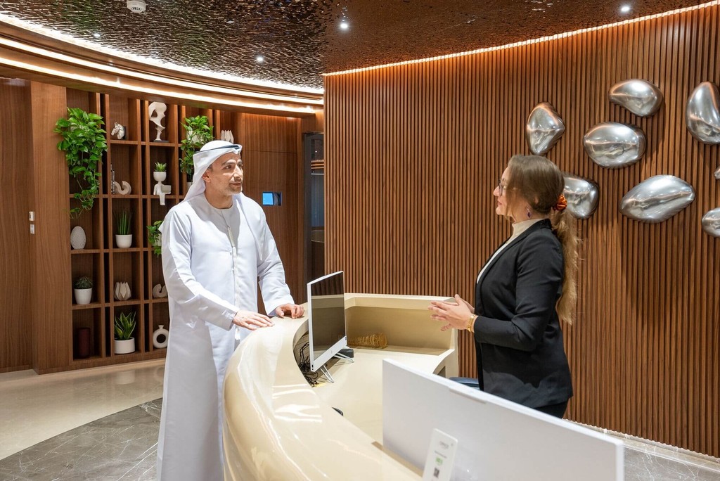 Business meeting at reception desk showcasing premium pro services Abu Dhabi in a sleek corporate setting.