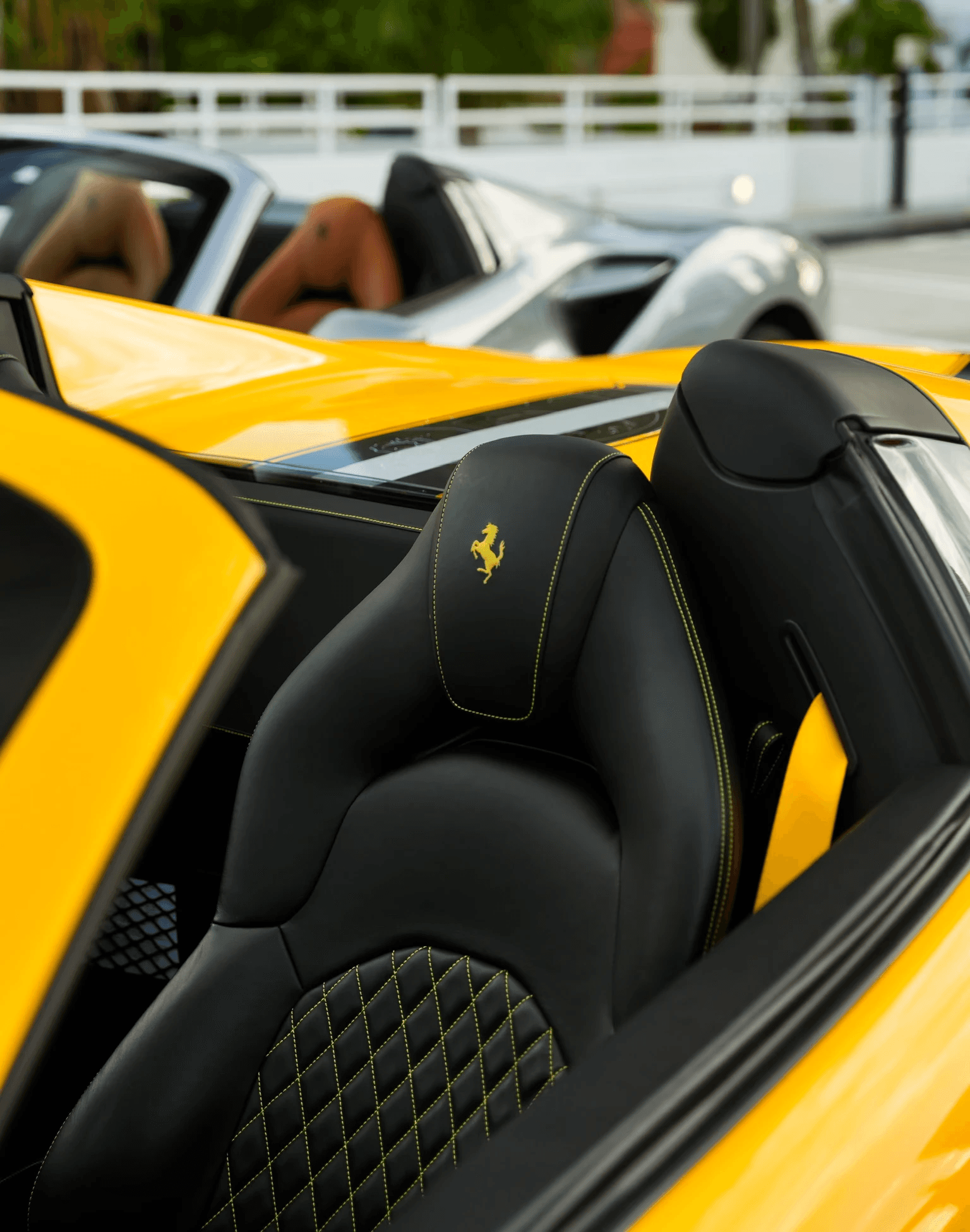 Interior of a car featuring sleek, modern seats, illuminated in a dark setting, emphasizing design and luxury.