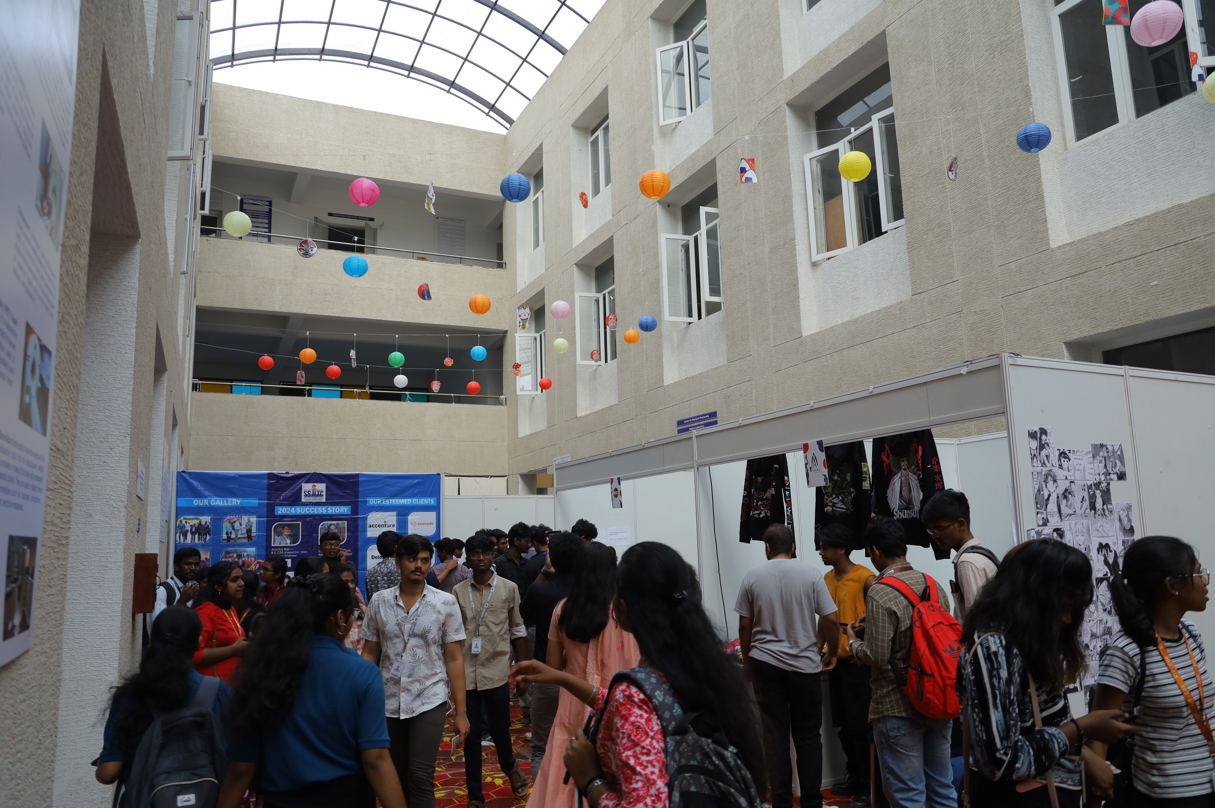 person discussing while standing in front of a large screen in front of people inside dim-lighted room