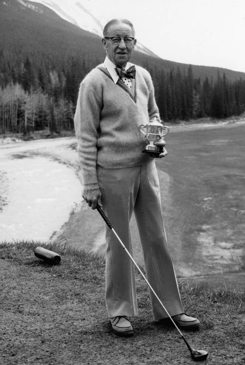 A man stading with Surfboard