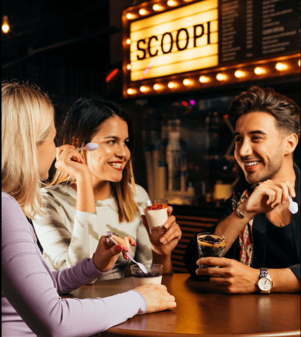 A group people laughing at a table, enjoying halal foods.