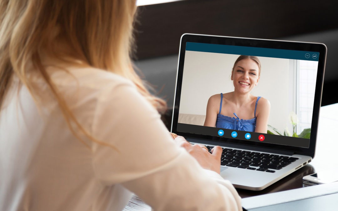 Telehealth counseling session with a woman meeting her therapist online from home