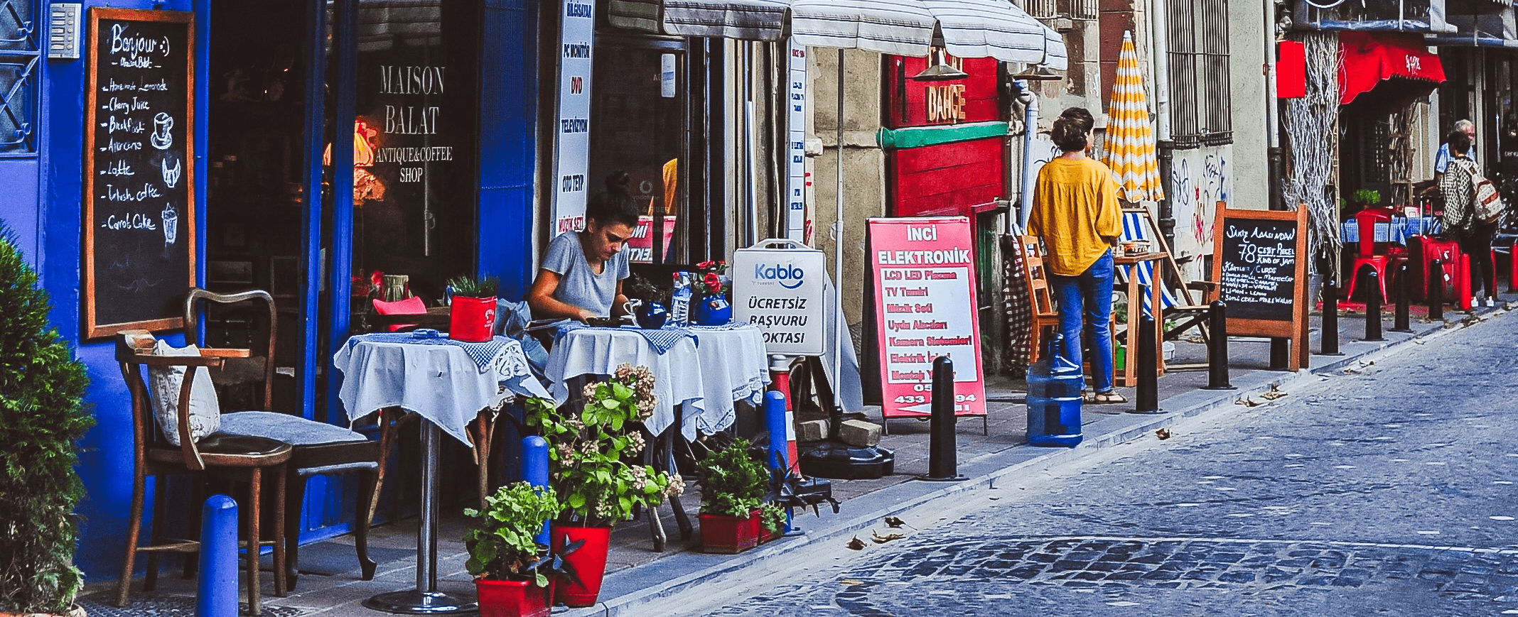 Colorful buildings line a european street with outdoor cafes.