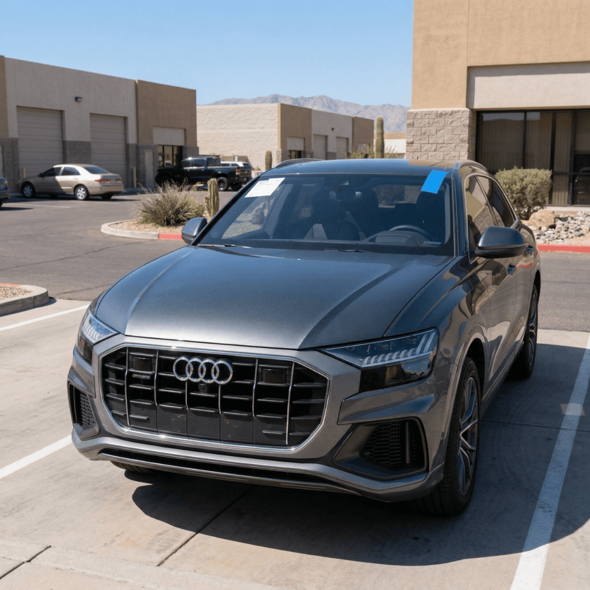 Tan Audi Q5 Sportback resting in an El Mirage driveway after Bang AutoGlass finished an auto glass swap