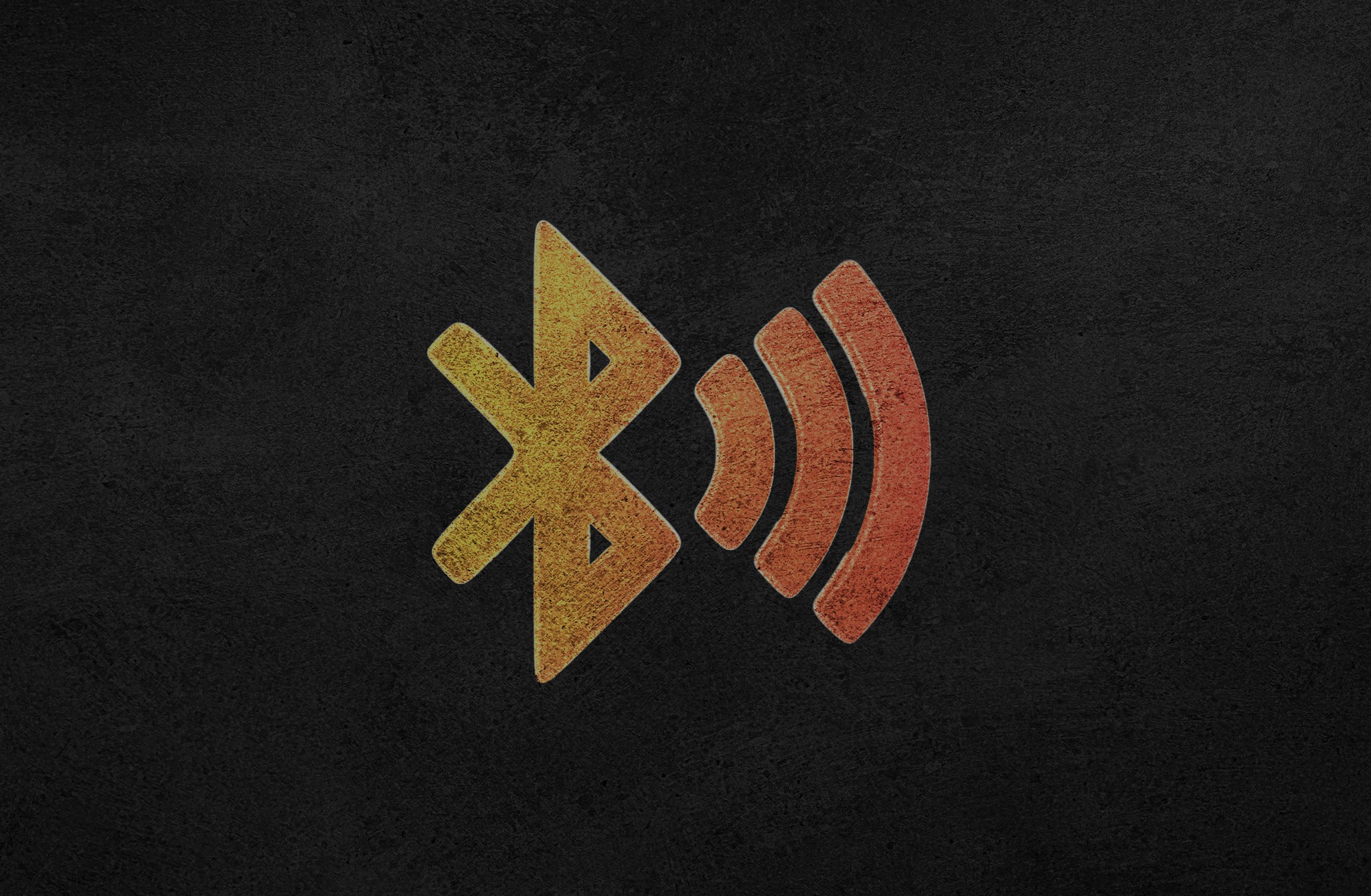 Yellow and orange Bluetooth sign on a black background.