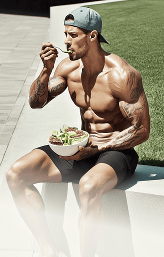 Muscular man running outdoors shirtless in an urban environment, showcasing strength, focus, and determination.