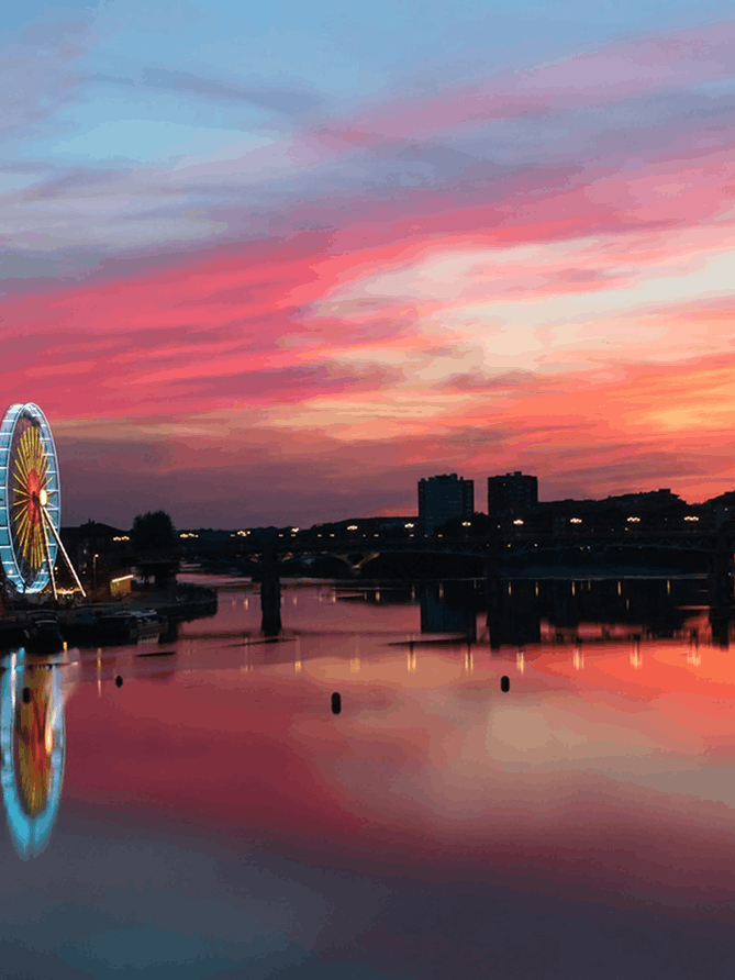 an airplane flying in the sky over a building
