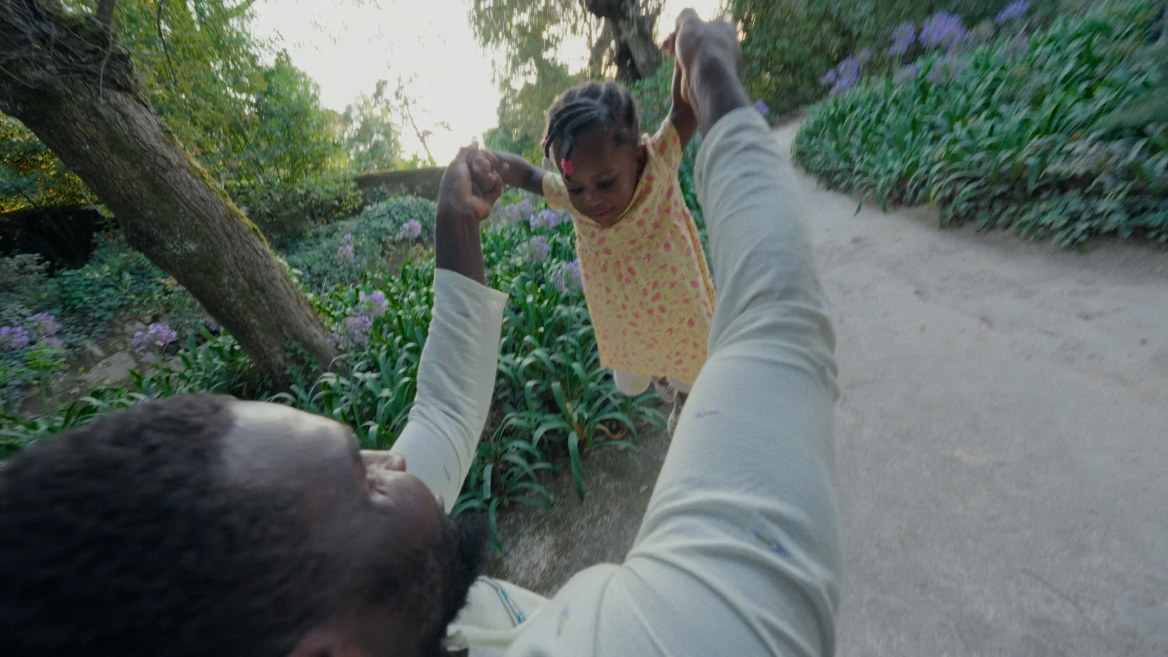 Frame from life among worlds with a man holding his daughter