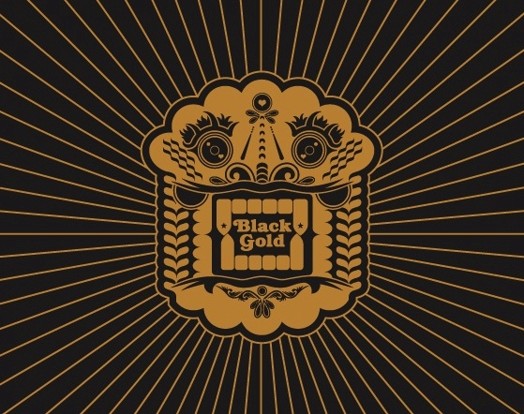 A black and gold colored drawing of a shape from Latin American culture with the text: Black Gold.
