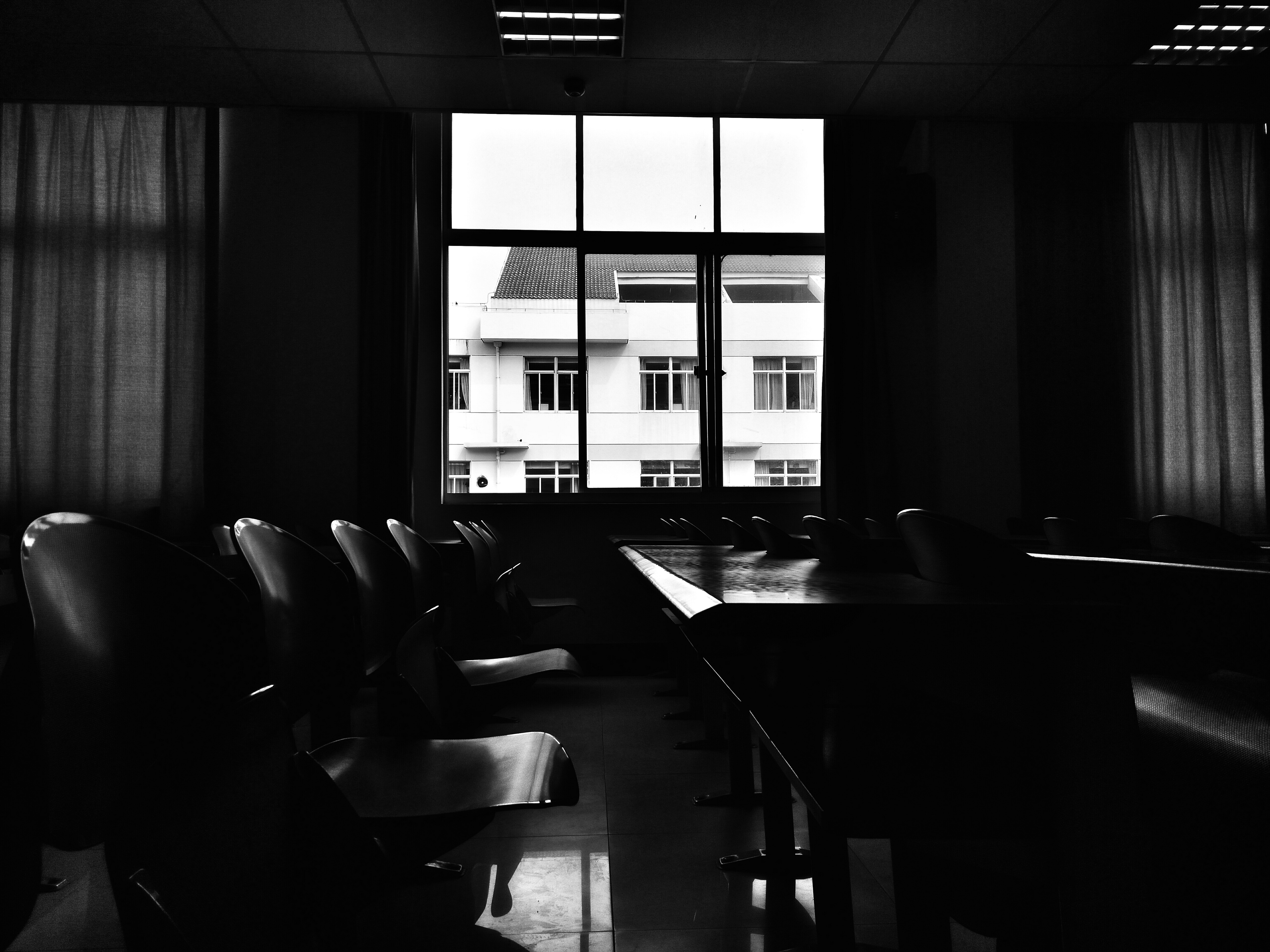 Black and white image of a stylish, modern living room.