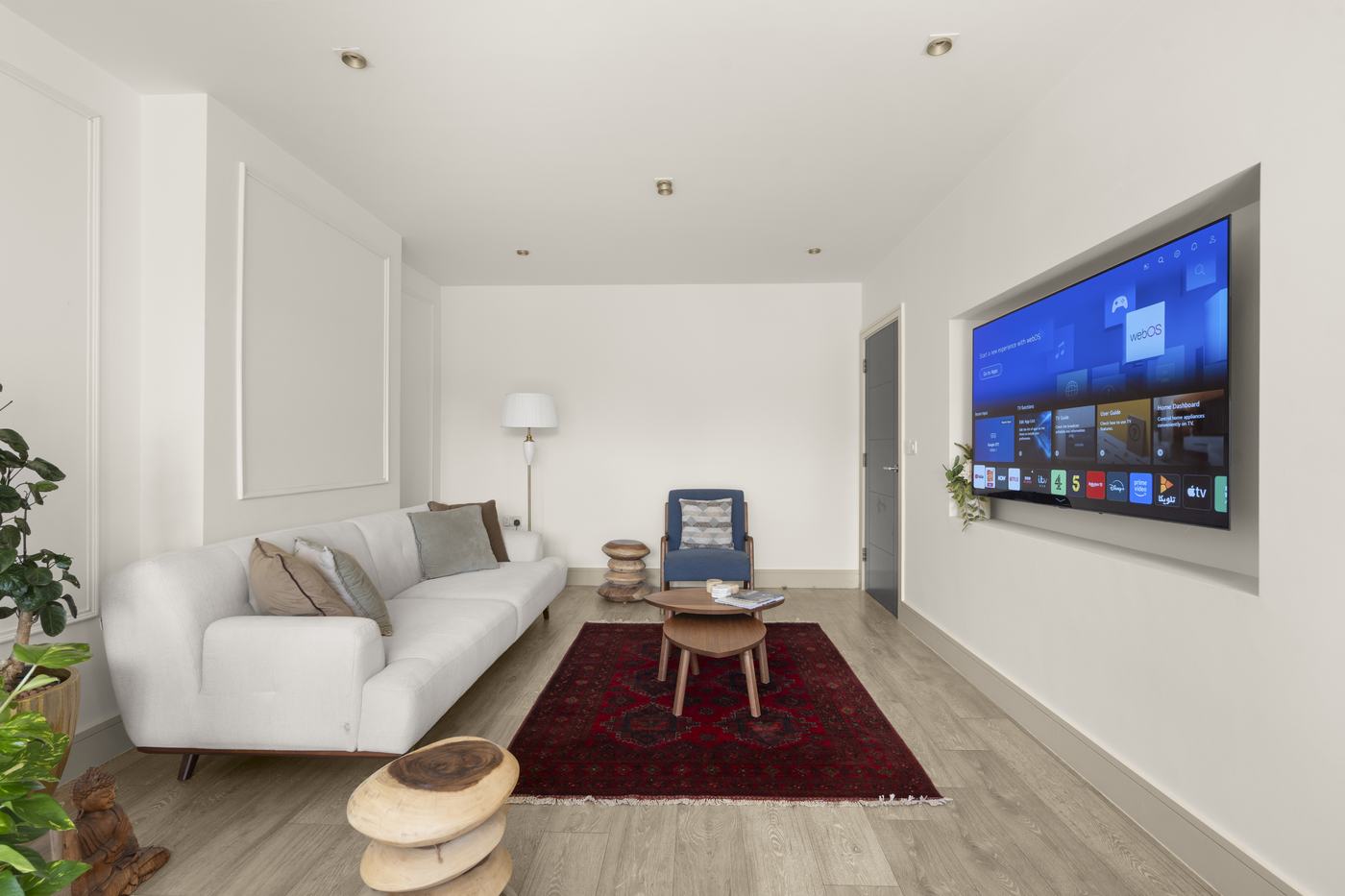 Living room with sofa and rug looking through to the dining space, High Barnet Airbnb