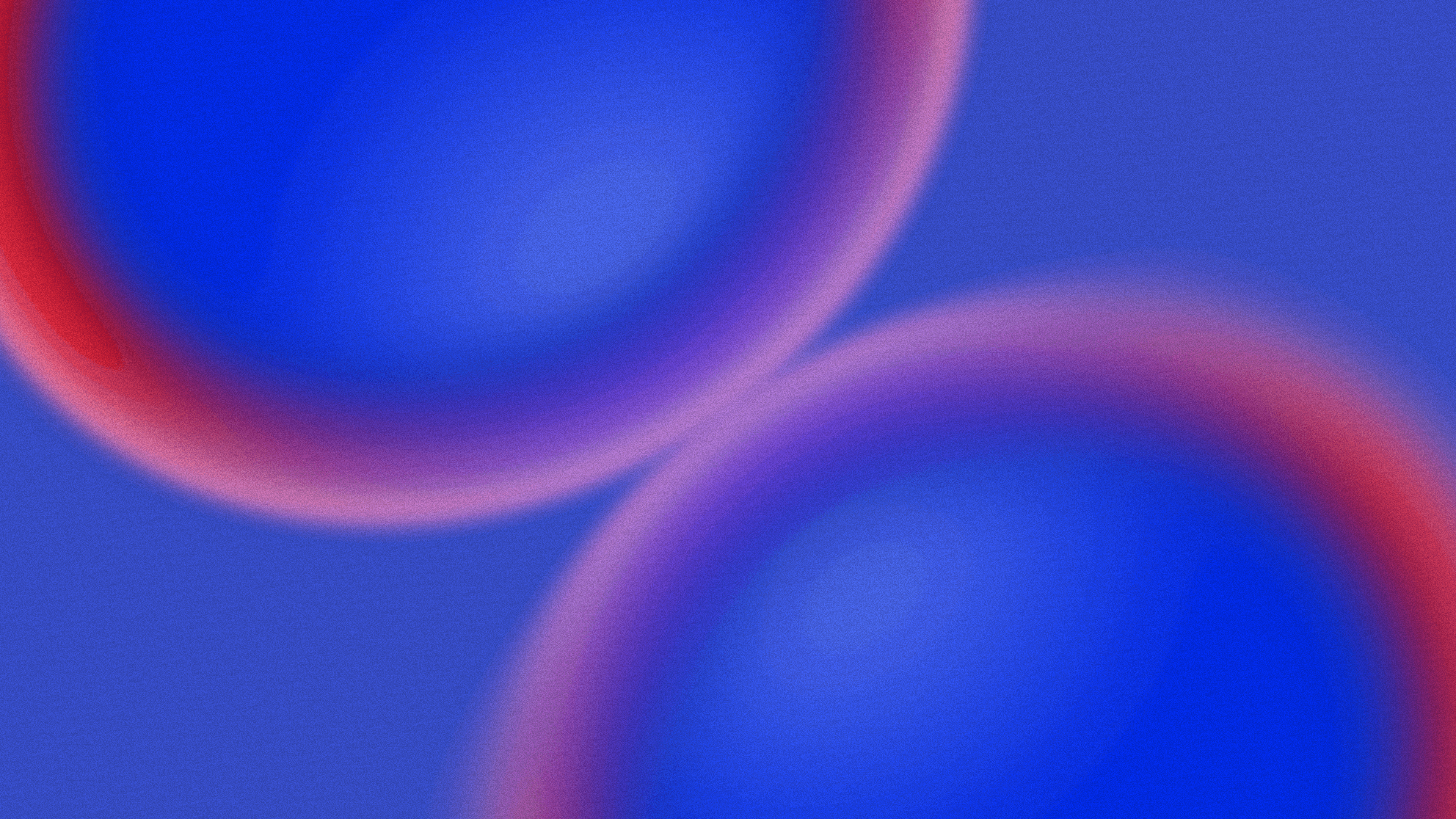 A modern building with sleek, curved surfaces against a cloudy sky, emphasizing minimalist architecture.