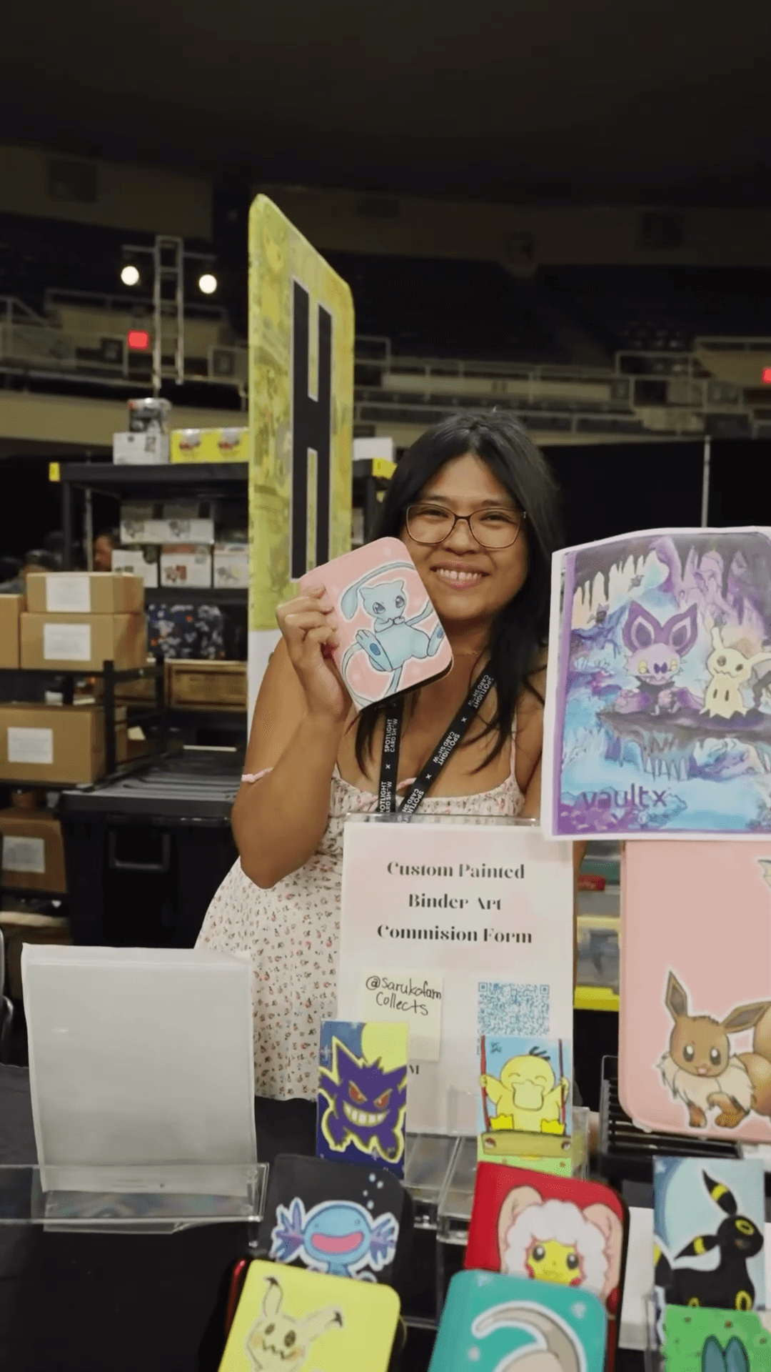 Vendor showing off binders and cards at Spotlight Card Show