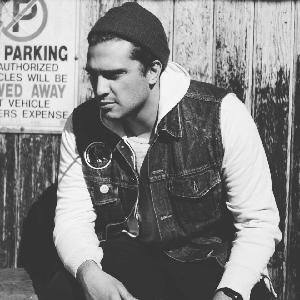 black & white picture of Jeremy Garcia wearing beanie and denim vest