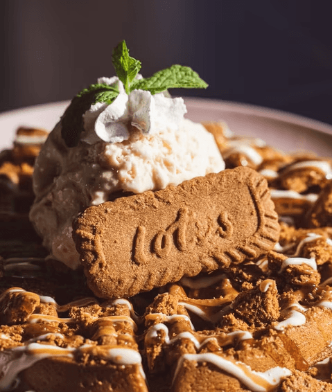 A close-up of a luxurious skincare jar with a gold lid, set against a soft, neutral background with gentle shadows.