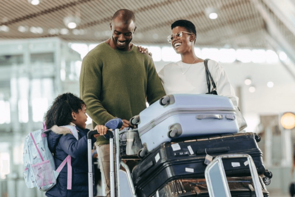 African kid talking with her parents at airport