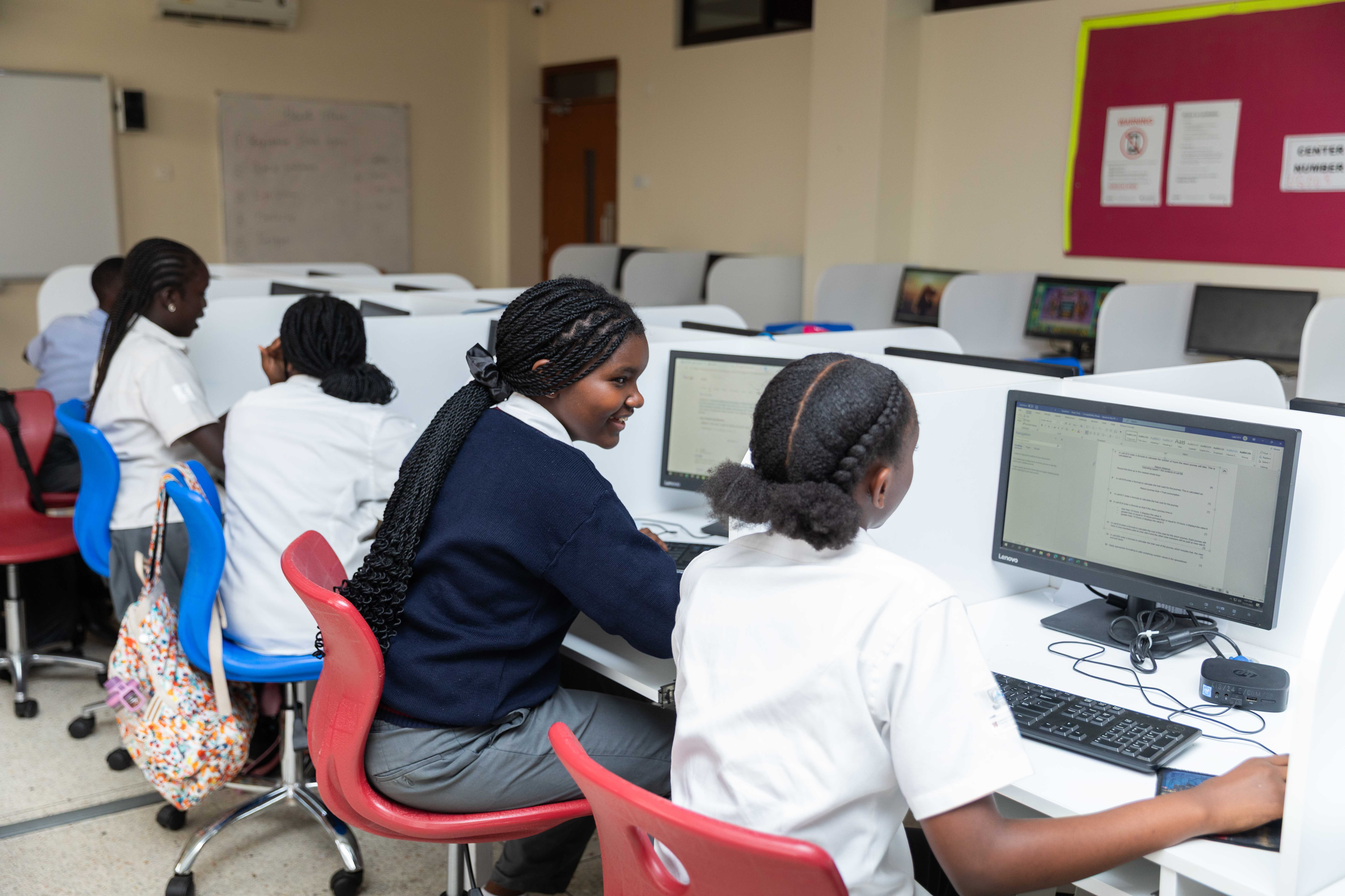 A schoolgirl participates in an online lesson using a tablet