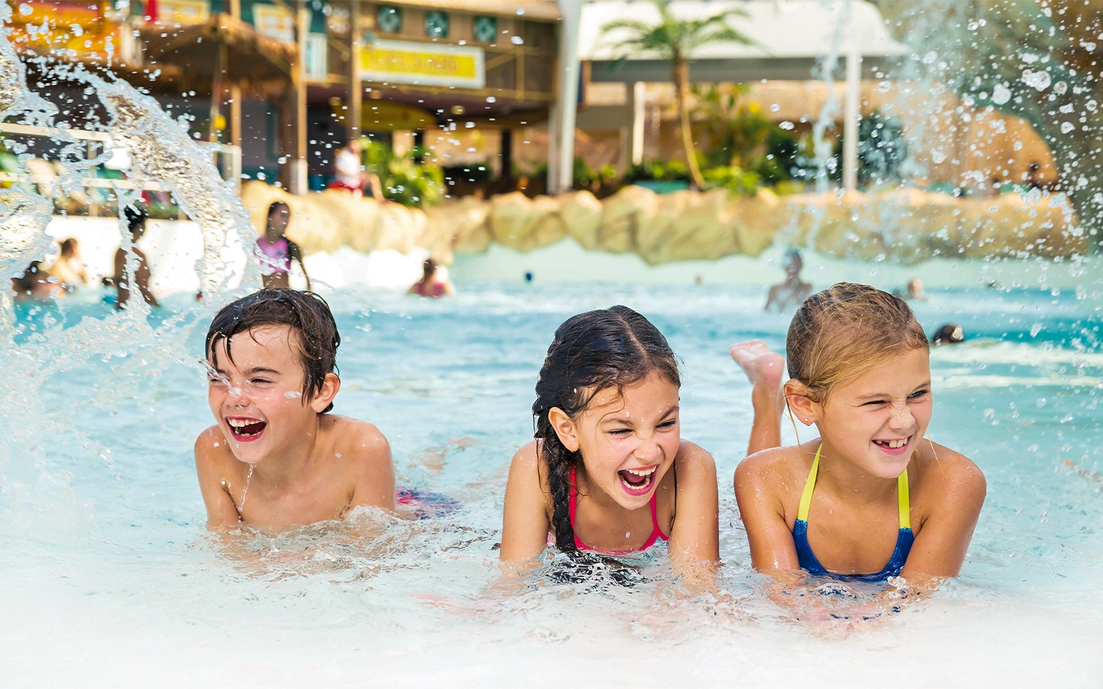 Kids playing in the wave pool at Aqualibi water park.