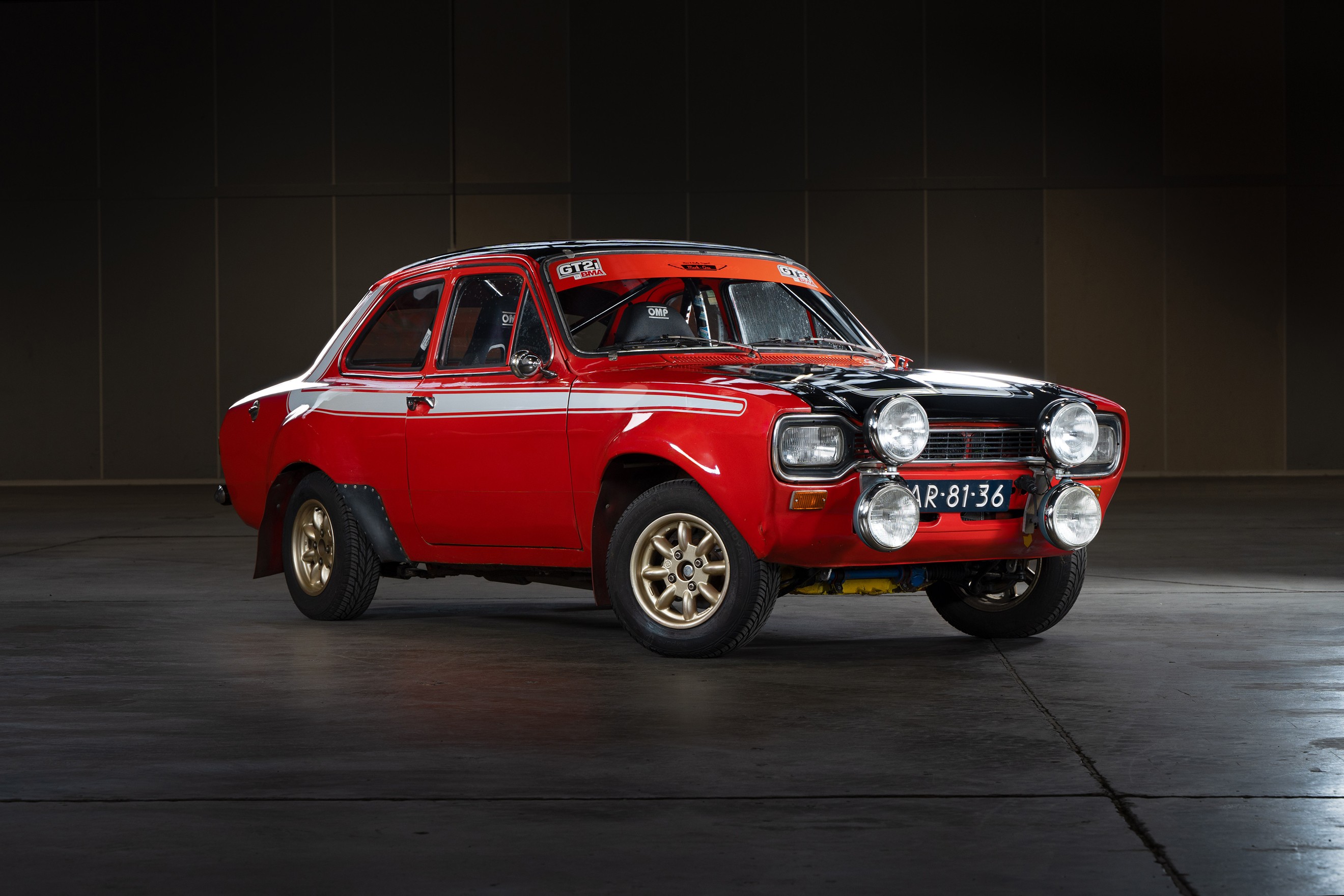 Lightyear 0 electric car showcased at its unveiling event in Spain, against a bright blue sky with scattered clouds, highlighting its futuristic design and aerodynamic lines.