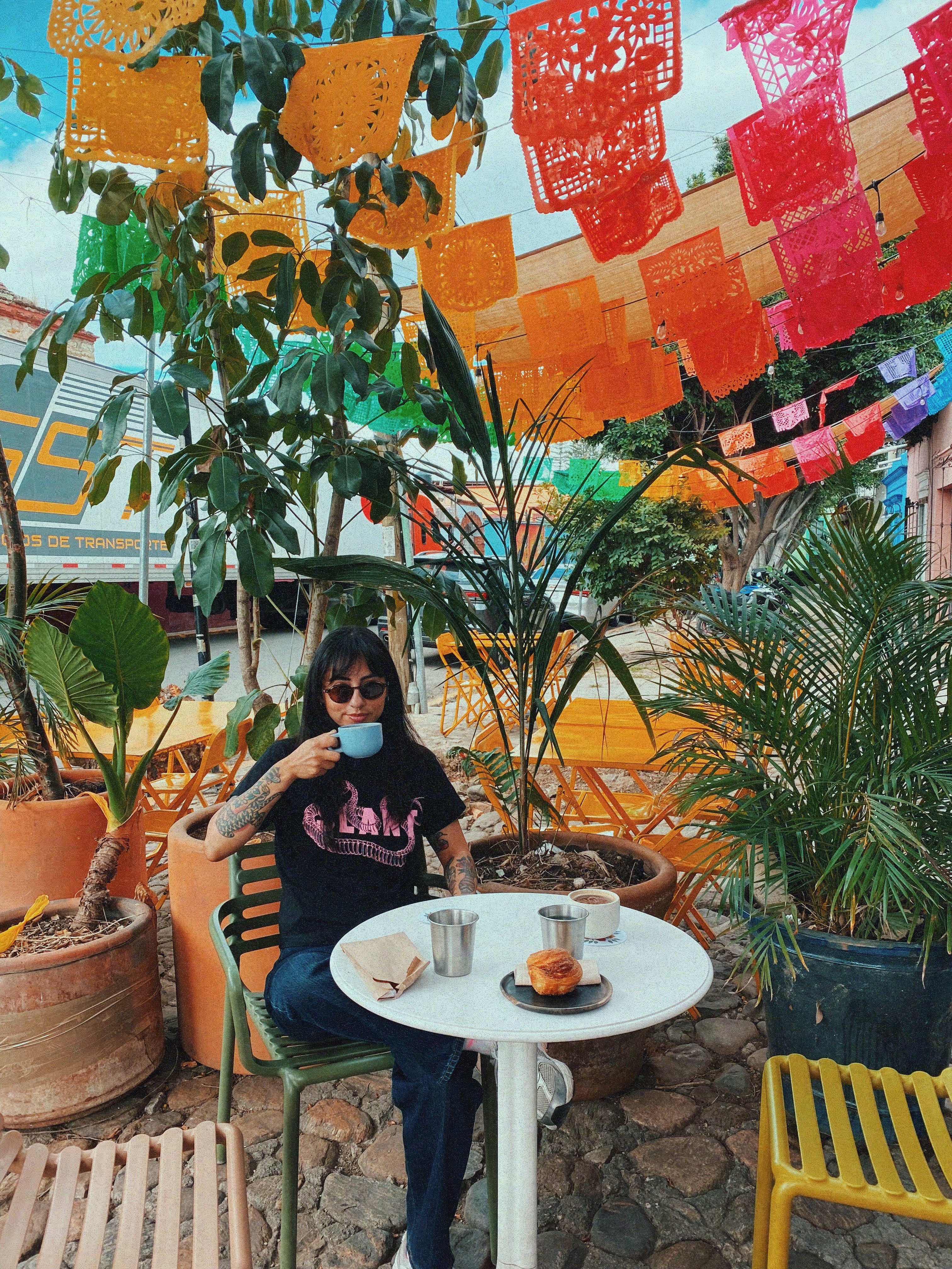 A thoughtful young person with dark hair gazes to the side, captured in soft black and white lighting.