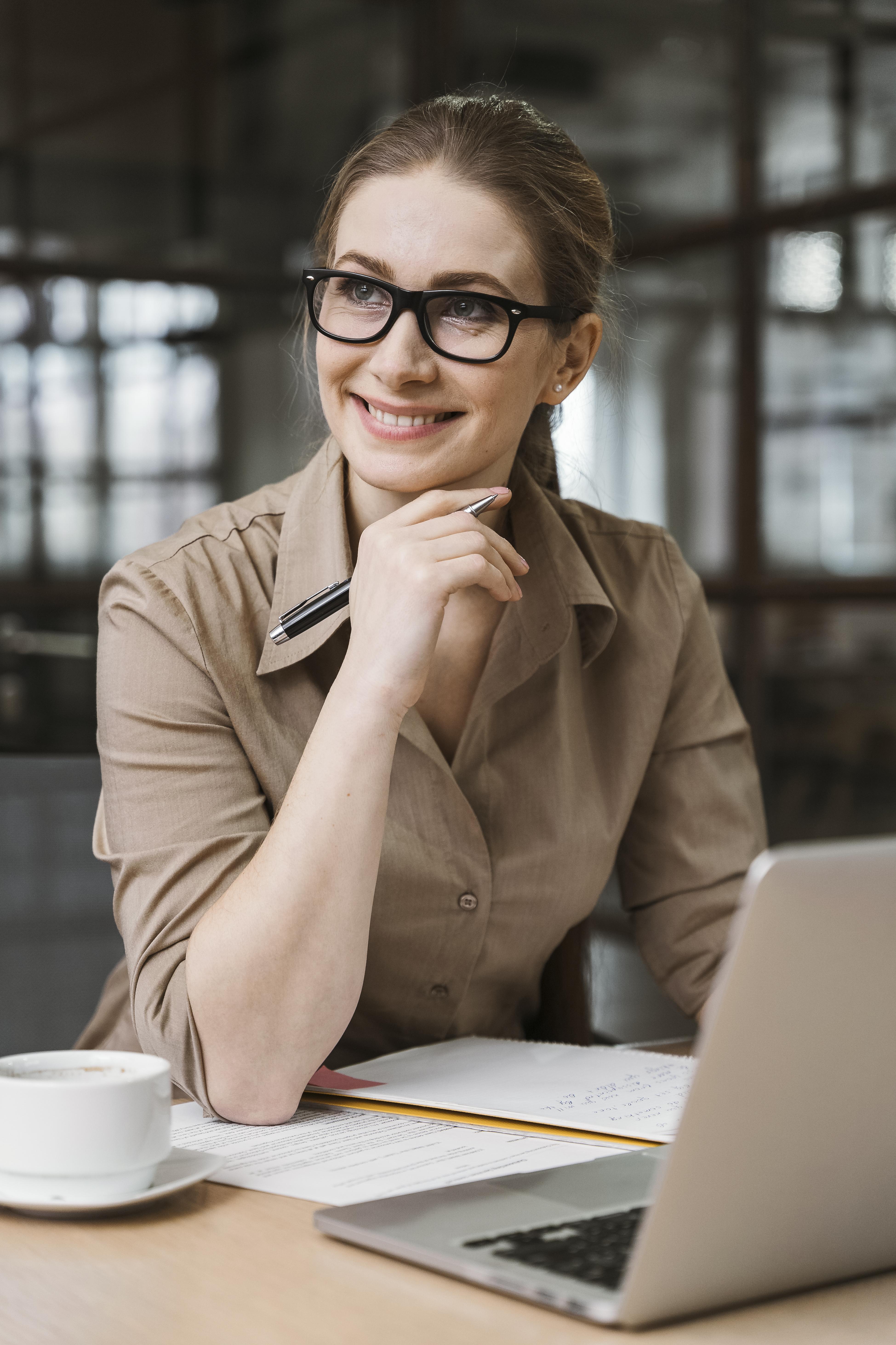 A woman works at a laptop