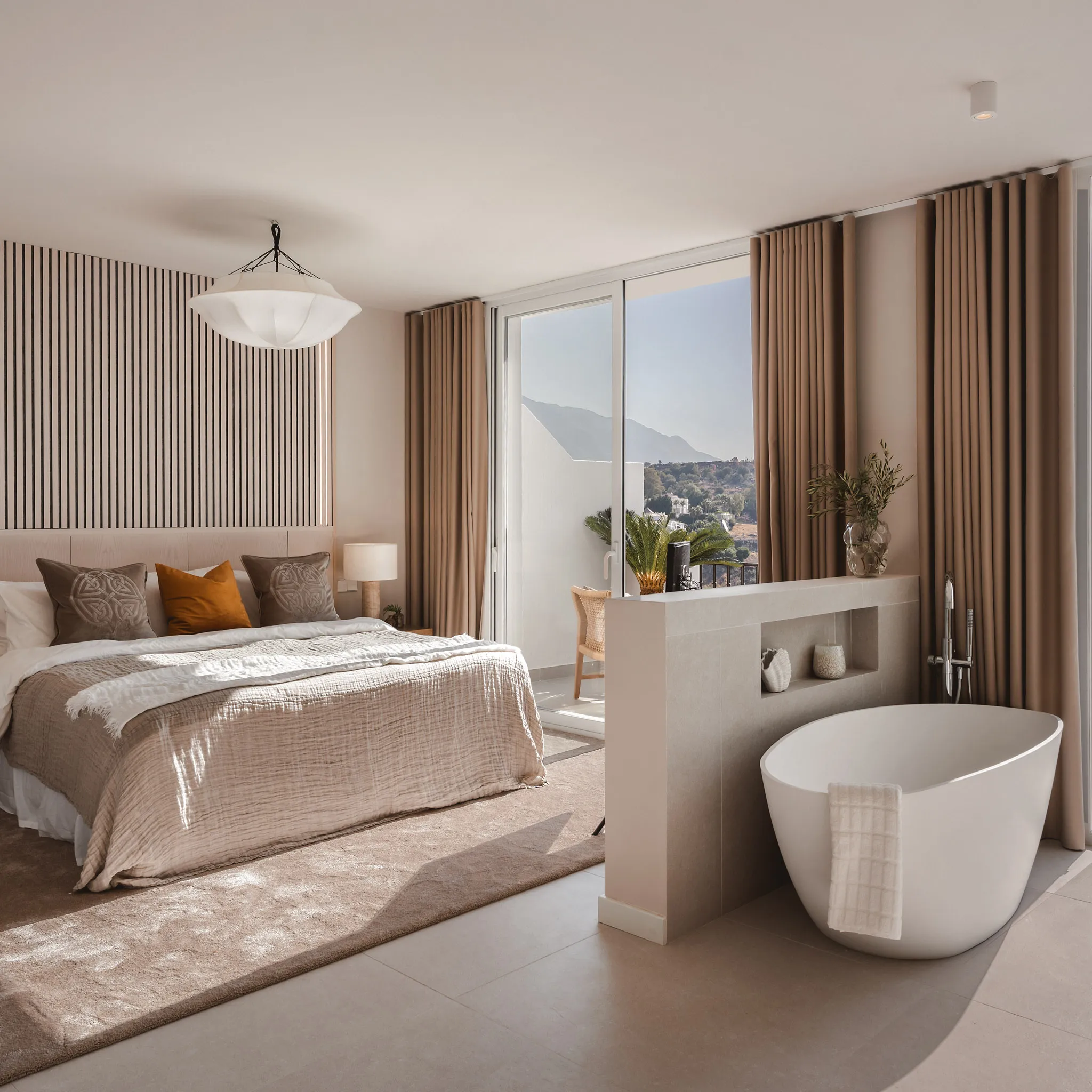 Master bedroom at La Quinta Townhouse with bespoke joinery and a freestanding bathtub