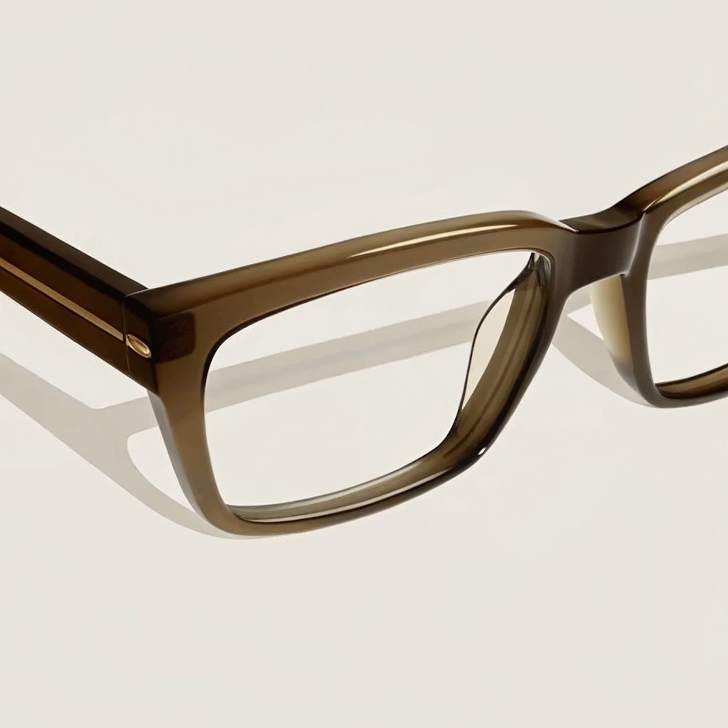Brown thick-rimmed glasses detail